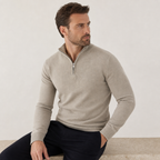Man seated in the beige quarter-zip sweater