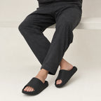 Black EVA platform slide slippers styled beside a bench