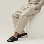 Black EVA platform slide slippers worn while seated