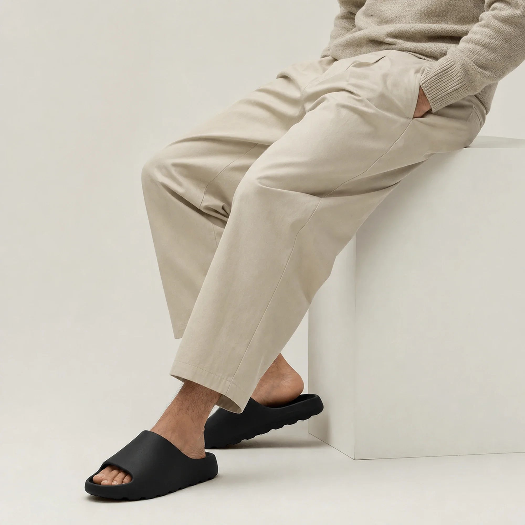 Black EVA platform slide slippers worn while seated