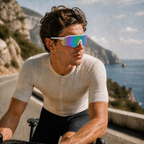 ACE Prism rainbow sports sunglasses worn by cyclist on coastal road