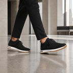 Men's black knit sock-fit sneakers in a refined lobby