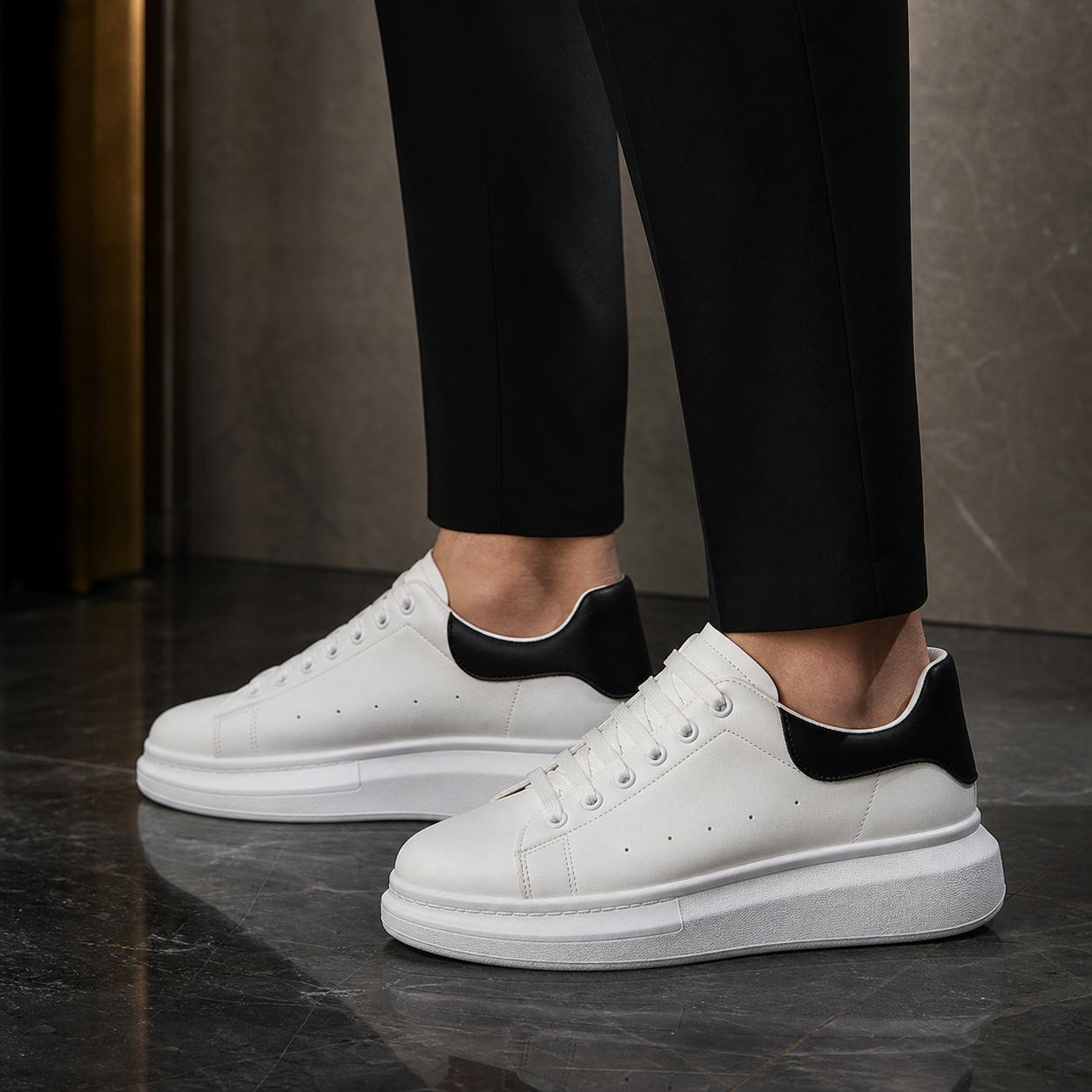 Men wearing white platform sneakers with black heels