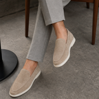 Men's beige suede loafers styled at a cafe