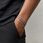 Three layered silver bracelets styled with minimalist black clothing